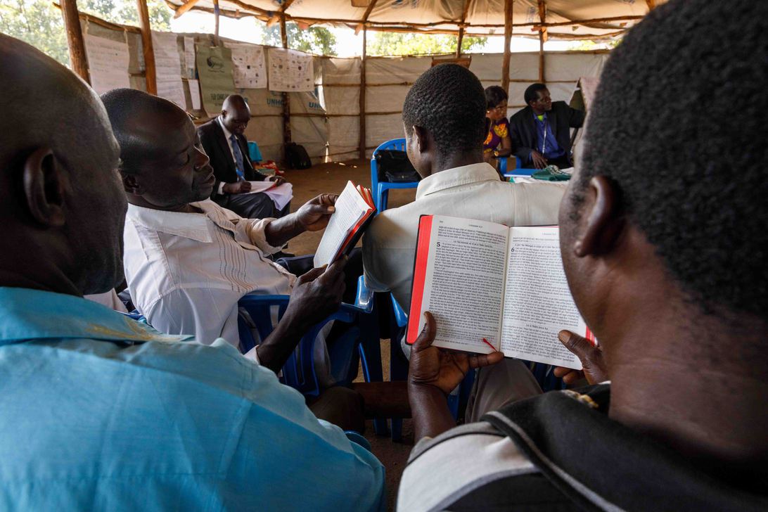 In an advanced literacy class, literacy specialist Elisa<br />
                                Anyani (back left) has students read the Keliko New Testament which sparks<br />
                                meaningful discussions.